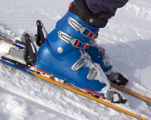 Alpine, or downhill, skis keep the booted foot attached to the ski.