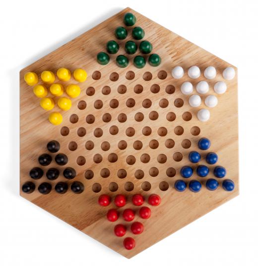 Chinese checkers are played with marbles and a board in the shape of a six-point star.