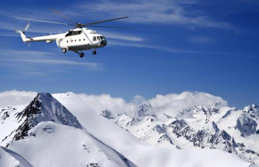 Heliskiers are airlifted to remote locations by helicopter.