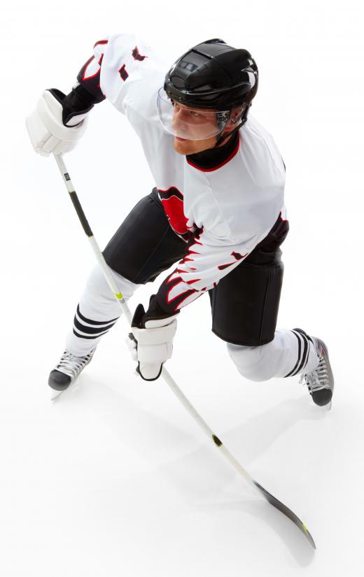 Hockey player wearing player skates.